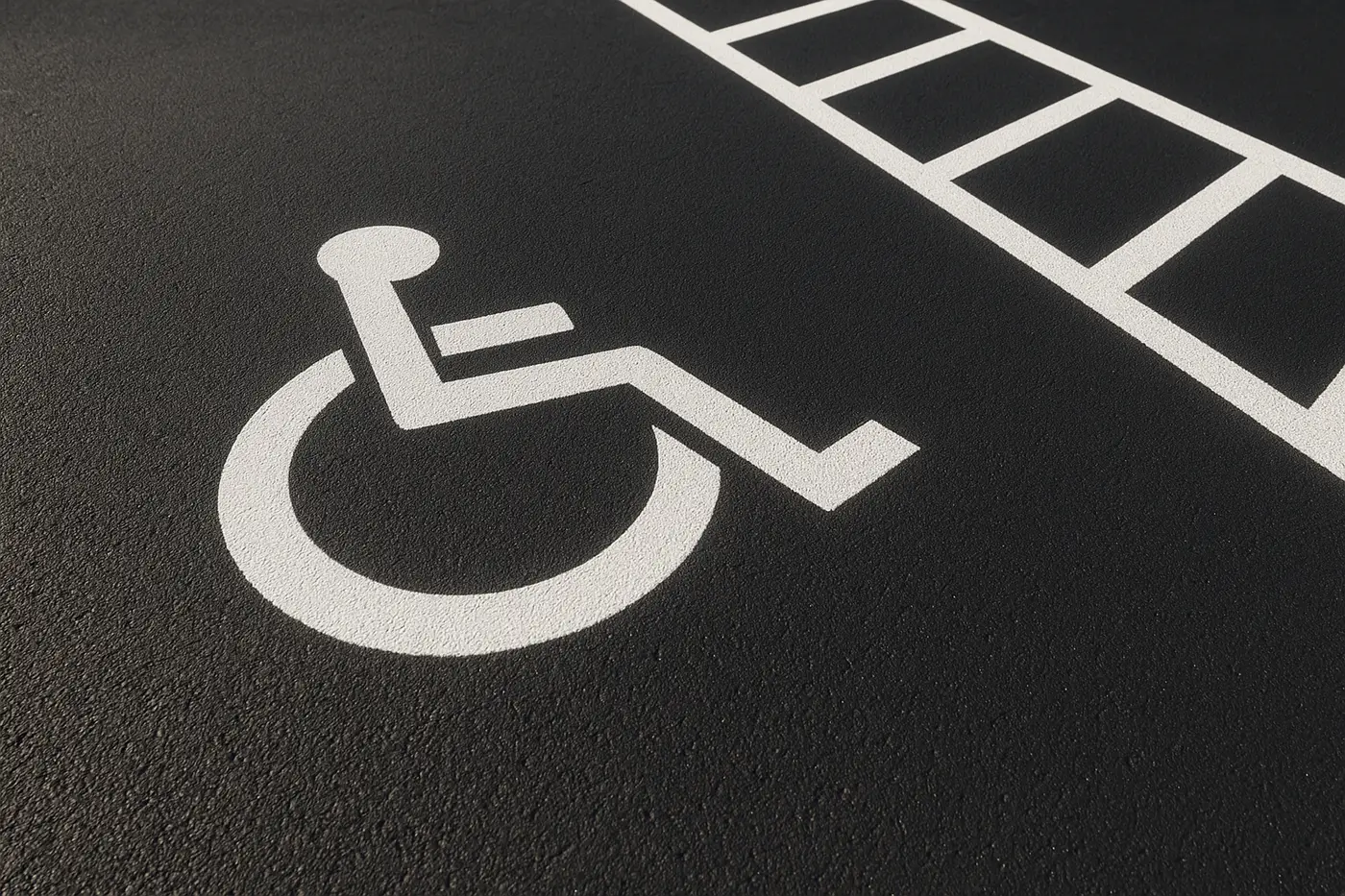 Accessible parking stall and access aisle marked on an asphalt lot