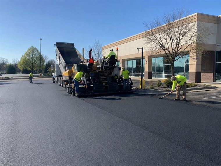 Tarmasters crew laying fresh asphalt with a paver