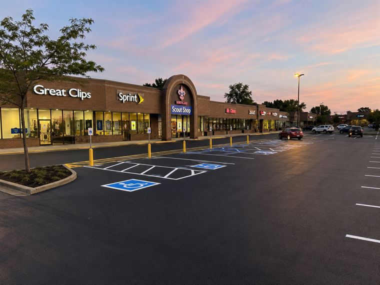 Freshly paved retail parking lot at dusk